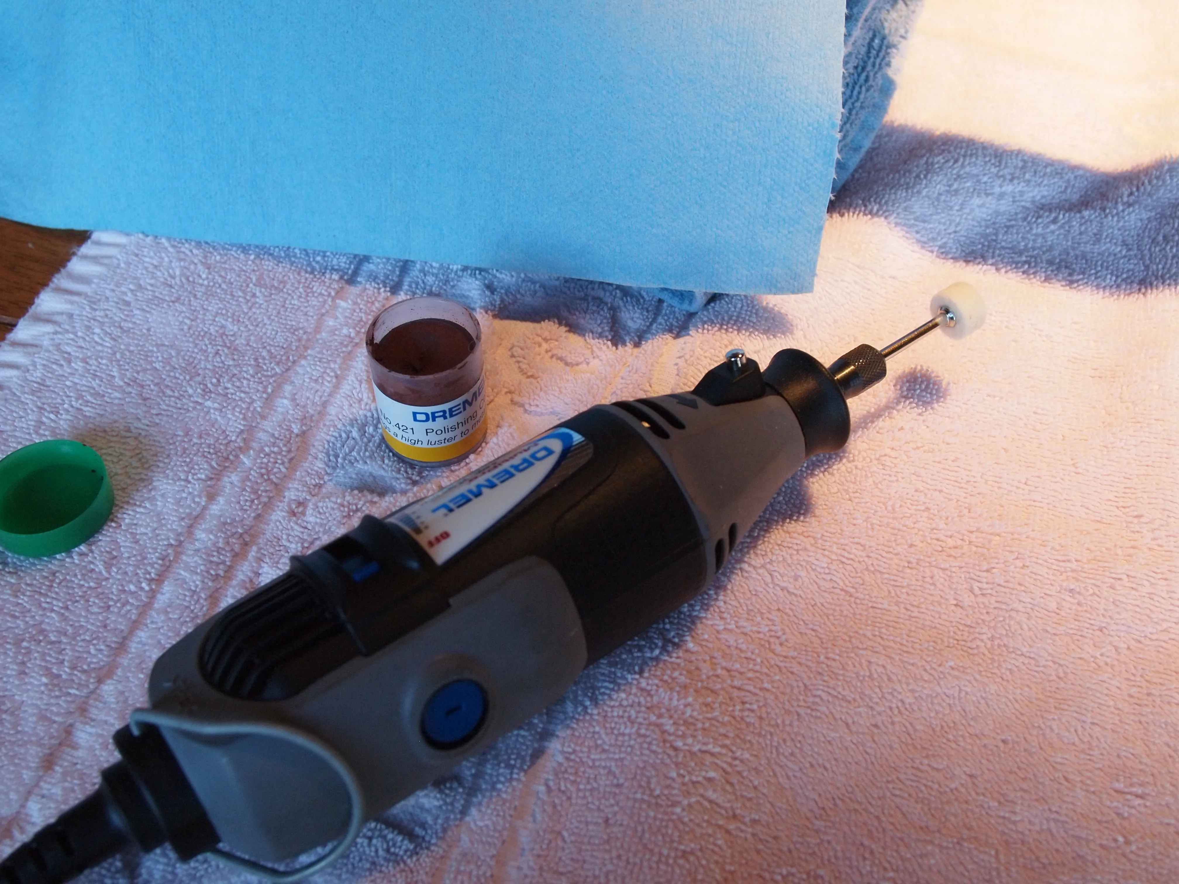 Standard Dremel Multi-Tool with the felt polishing disk and container of polishing compound.