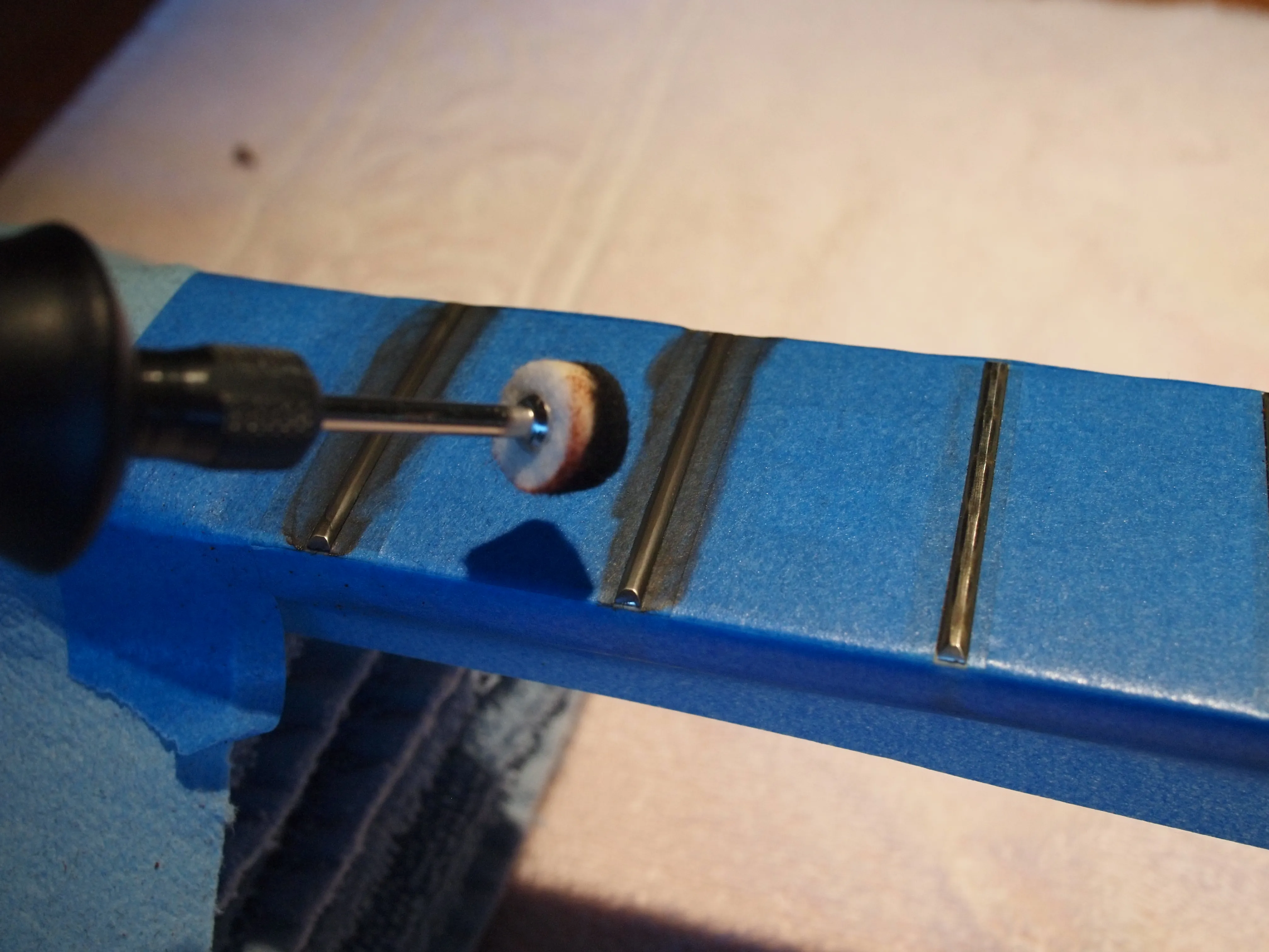 Set the Dremel to medium speed and spend about 20-30 seconds per fret until all of the fret surface is polished.