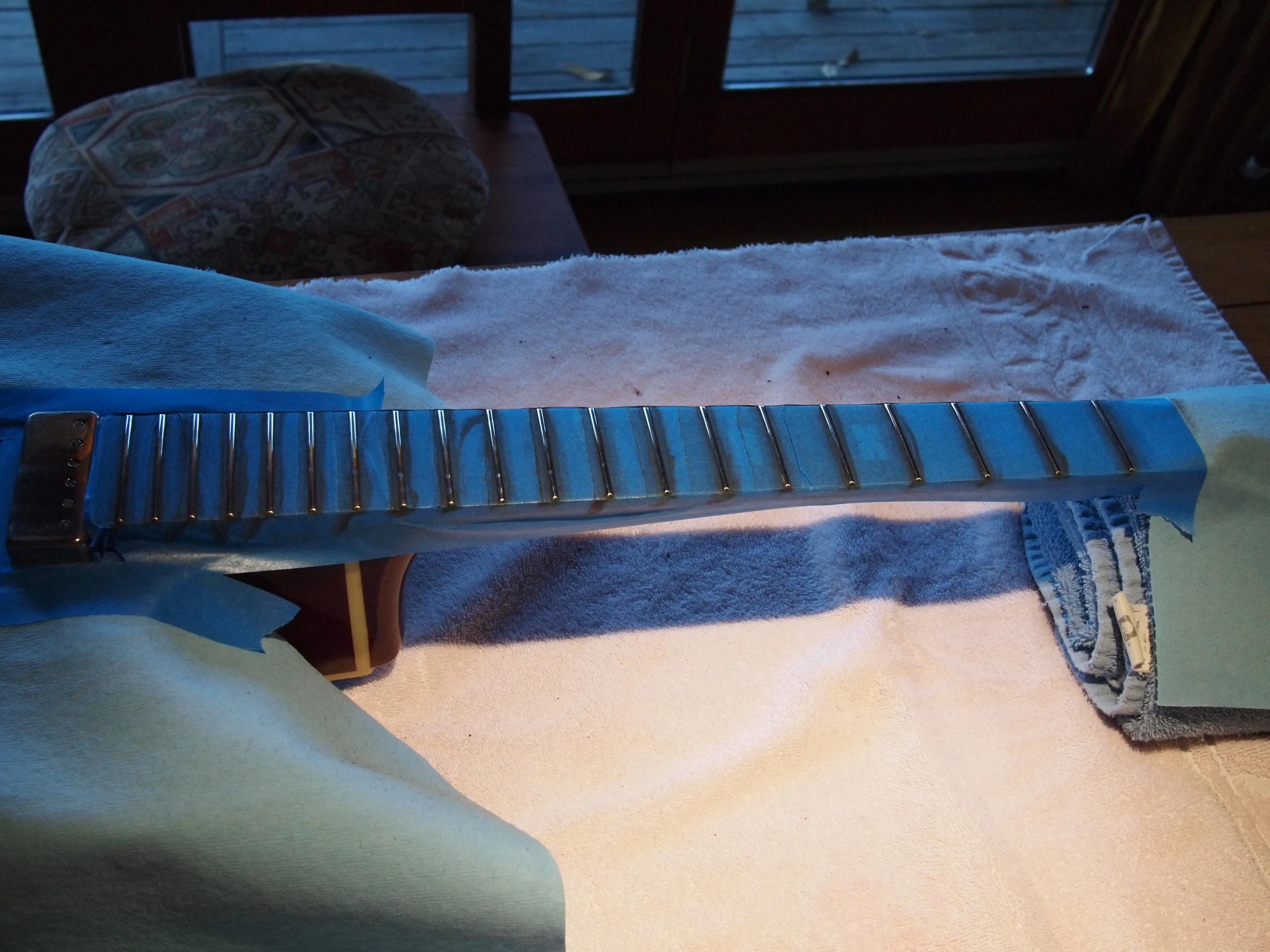 All frets polished and shiny, ready to remove the tape.